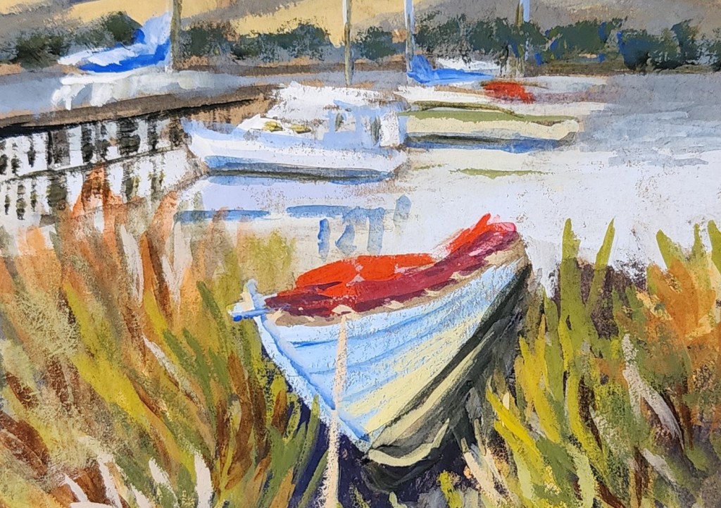 A rowboat on the riverbank with boats tied to the jetty.